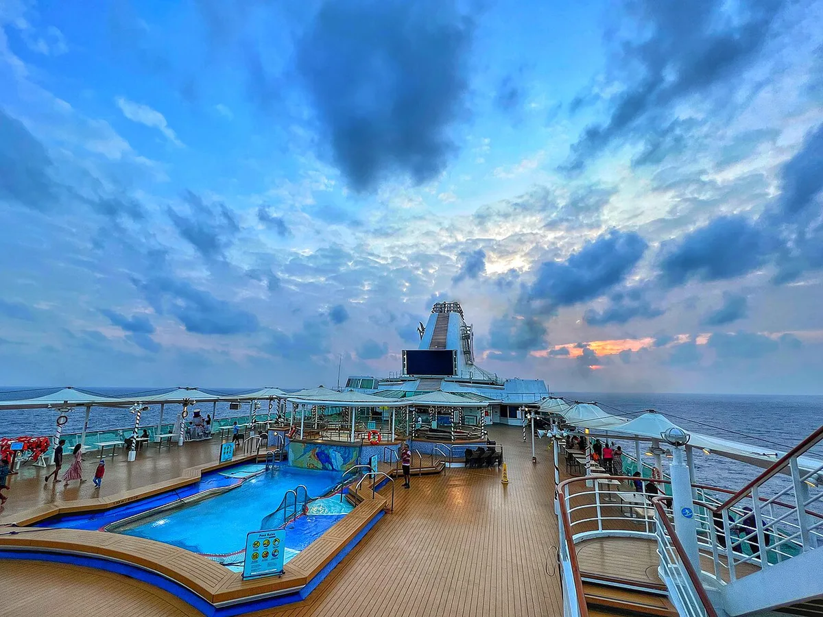 Cruise ship pool deck crowded with families at sea — 1