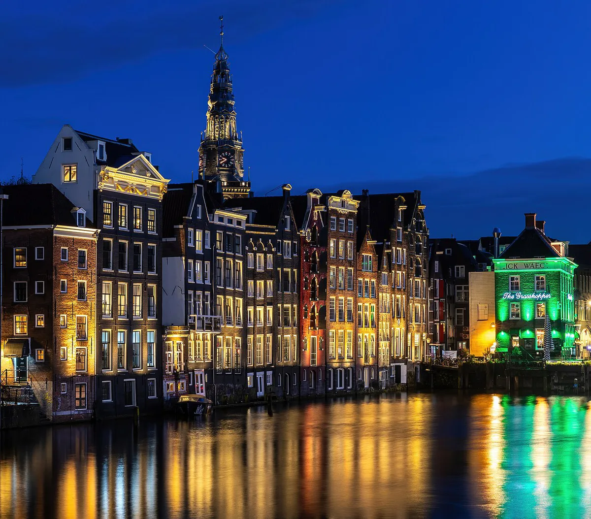 Glass-topped canal cruise boat passing gabled houses in Amsterdam — 2