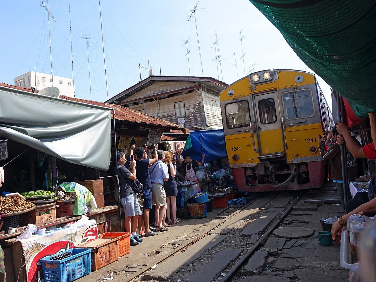 Train passing through Maeklong Railway Market (public domain) — 1