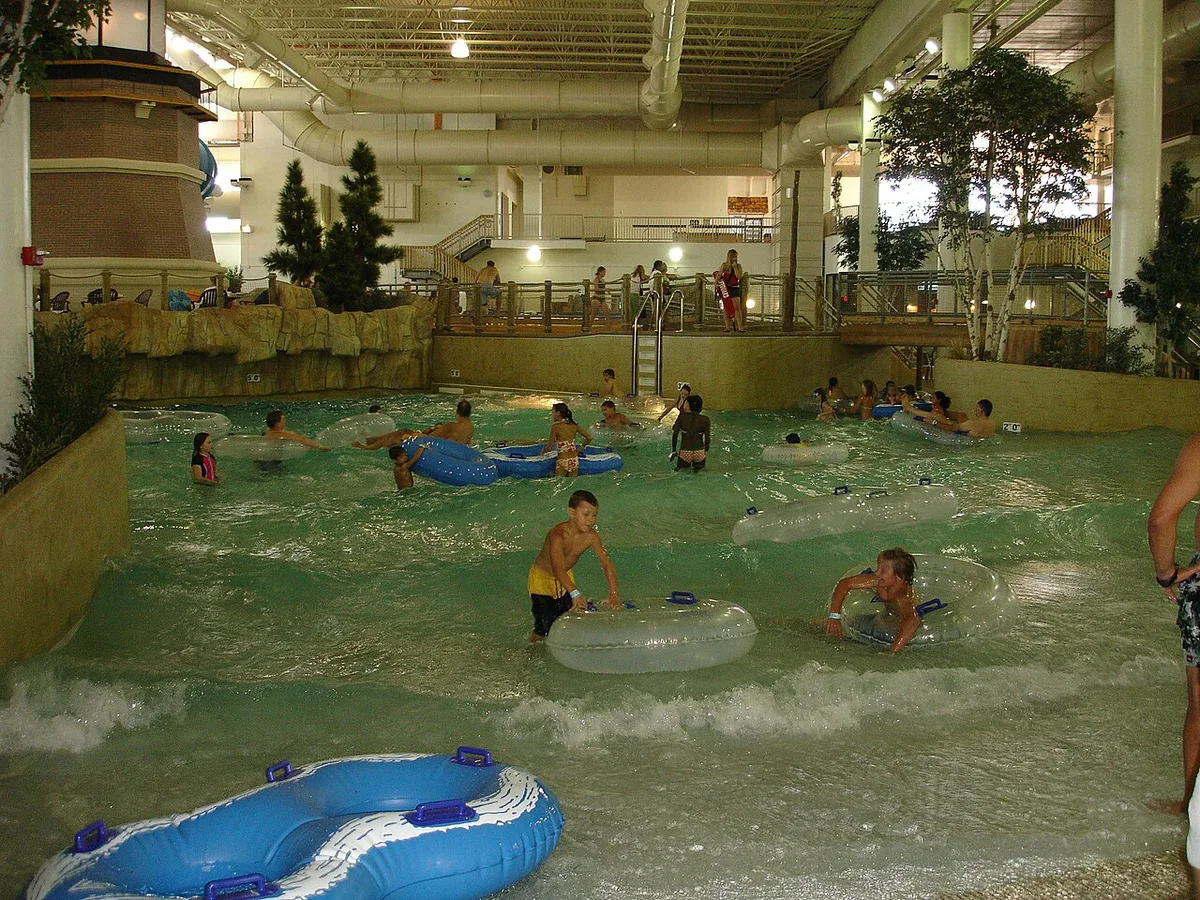 Colorful water slides and a wave pool at a busy family water park — 2