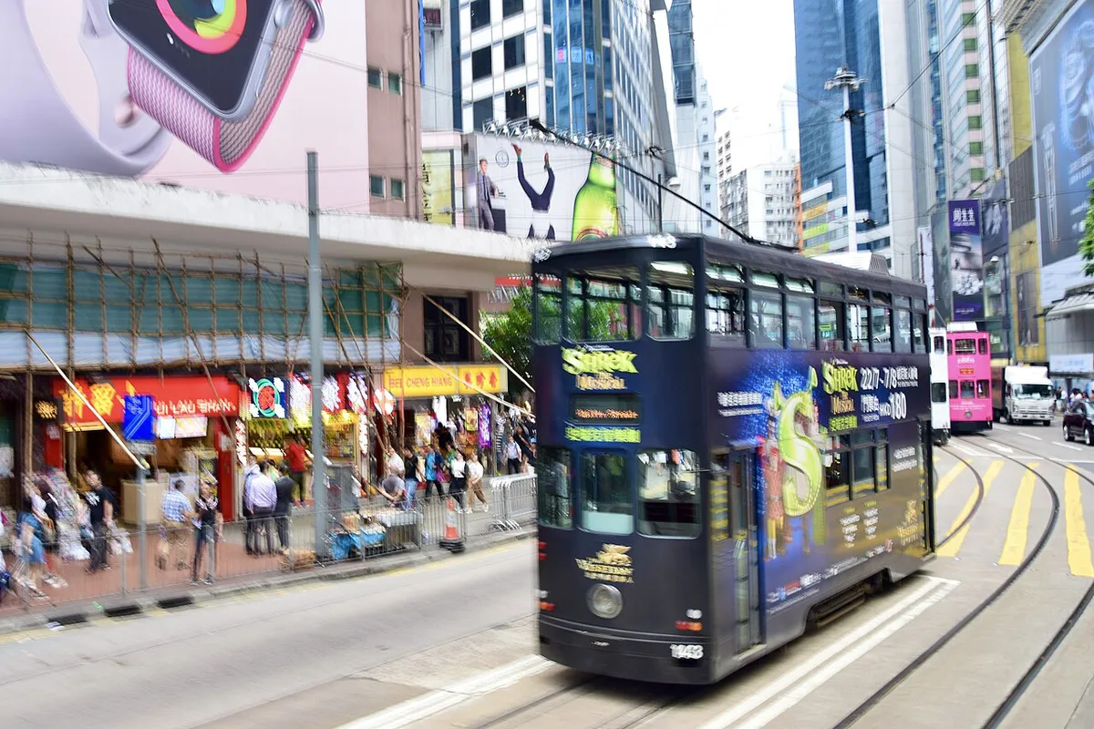 Green Star Ferry crossing Victoria Harbour with the Hong Kong skyline — 1