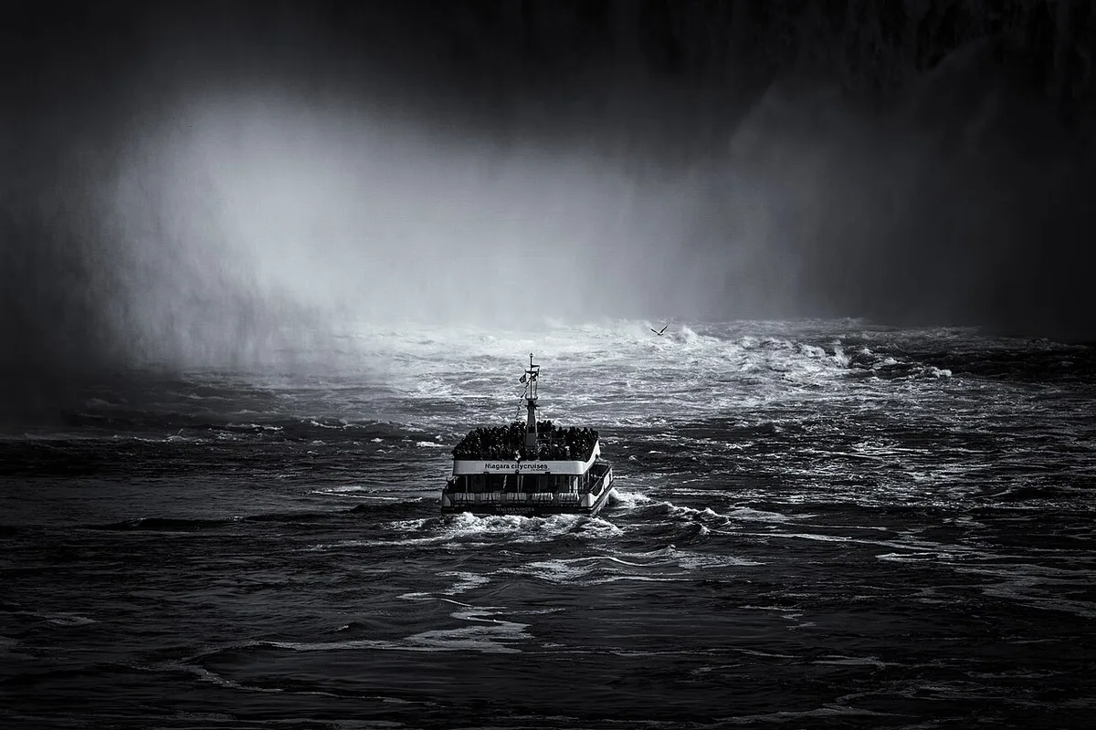 Poncho-clad passengers on a Niagara Falls boat tour approaching Horseshoe Falls — 1