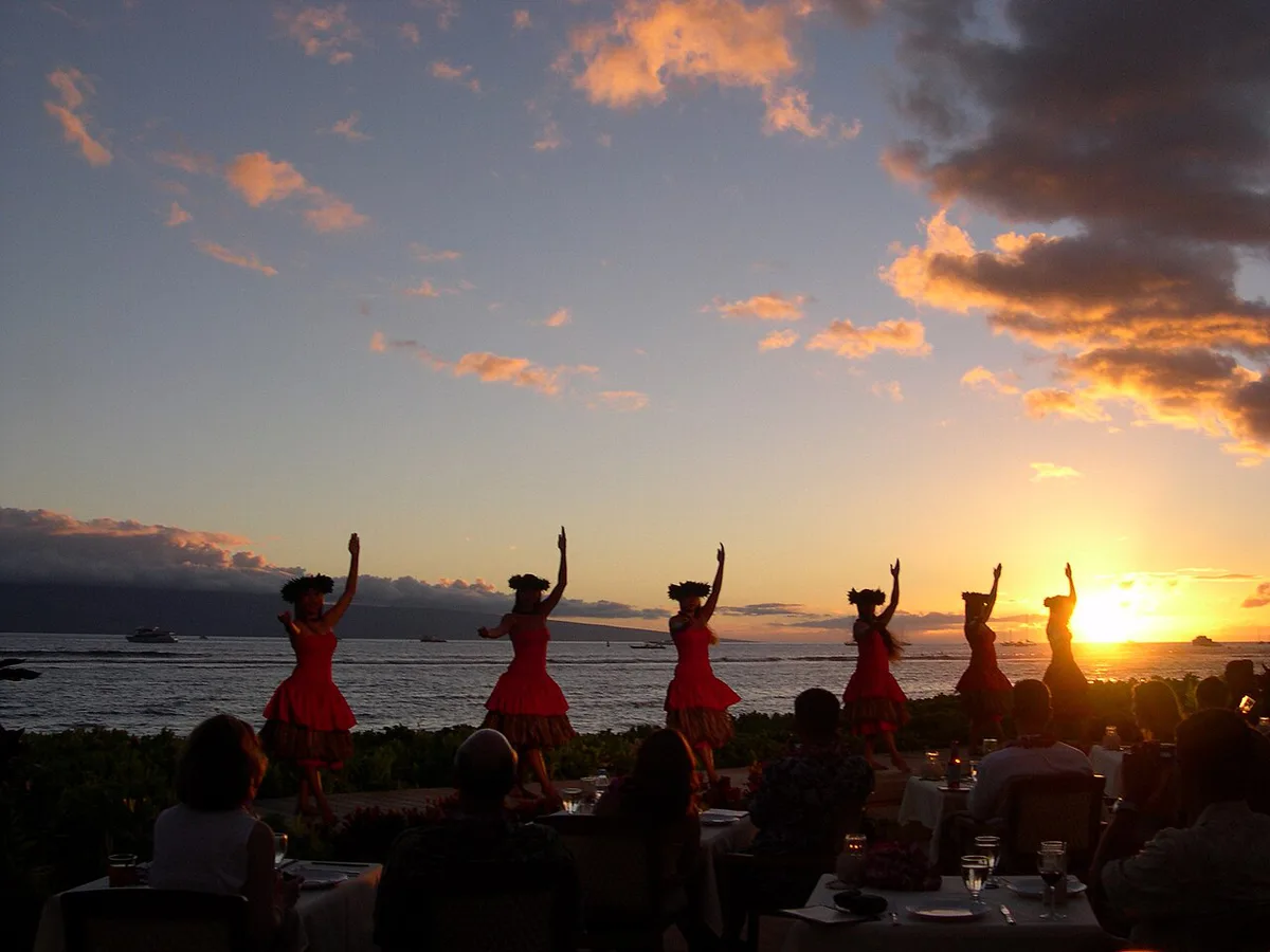 Fire knife dancer performing at a Maui luau at sunset — 1