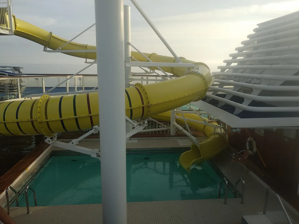 Large Royal Caribbean cruise ship with water slides on the top deck — 1