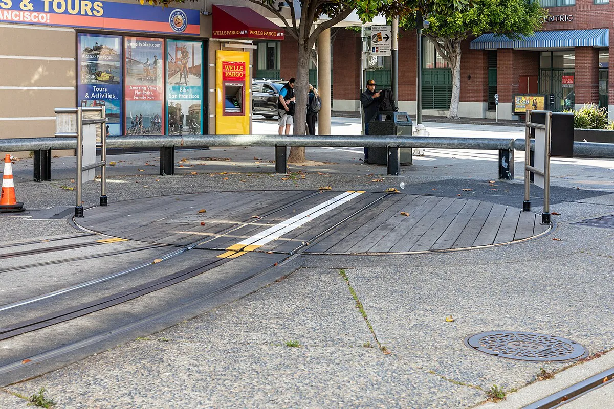 Cable car climbing a steep San Francisco hill with the bay behind — 1