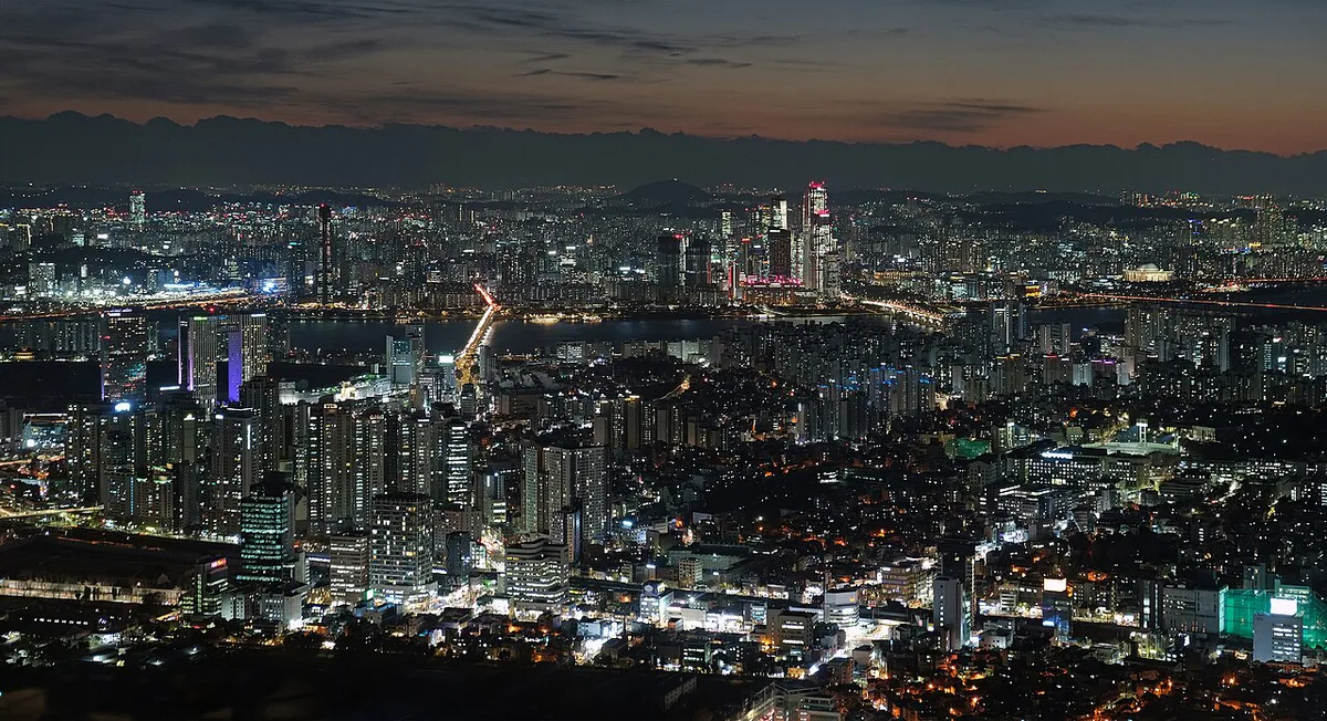 Gyeongbokgung Palace rooftops with N Seoul Tower on Namsan behind — 1