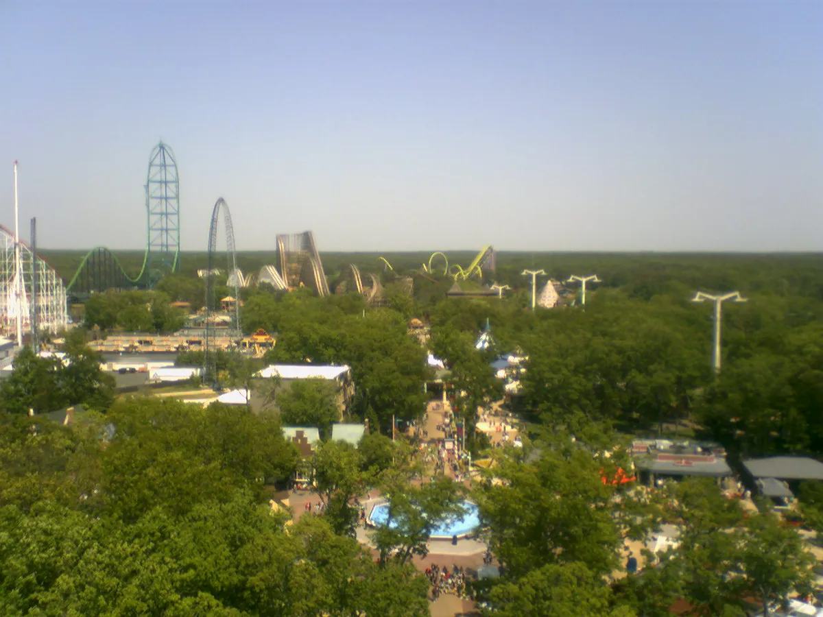 Looping roller coaster towering over a Six Flags midway — 1