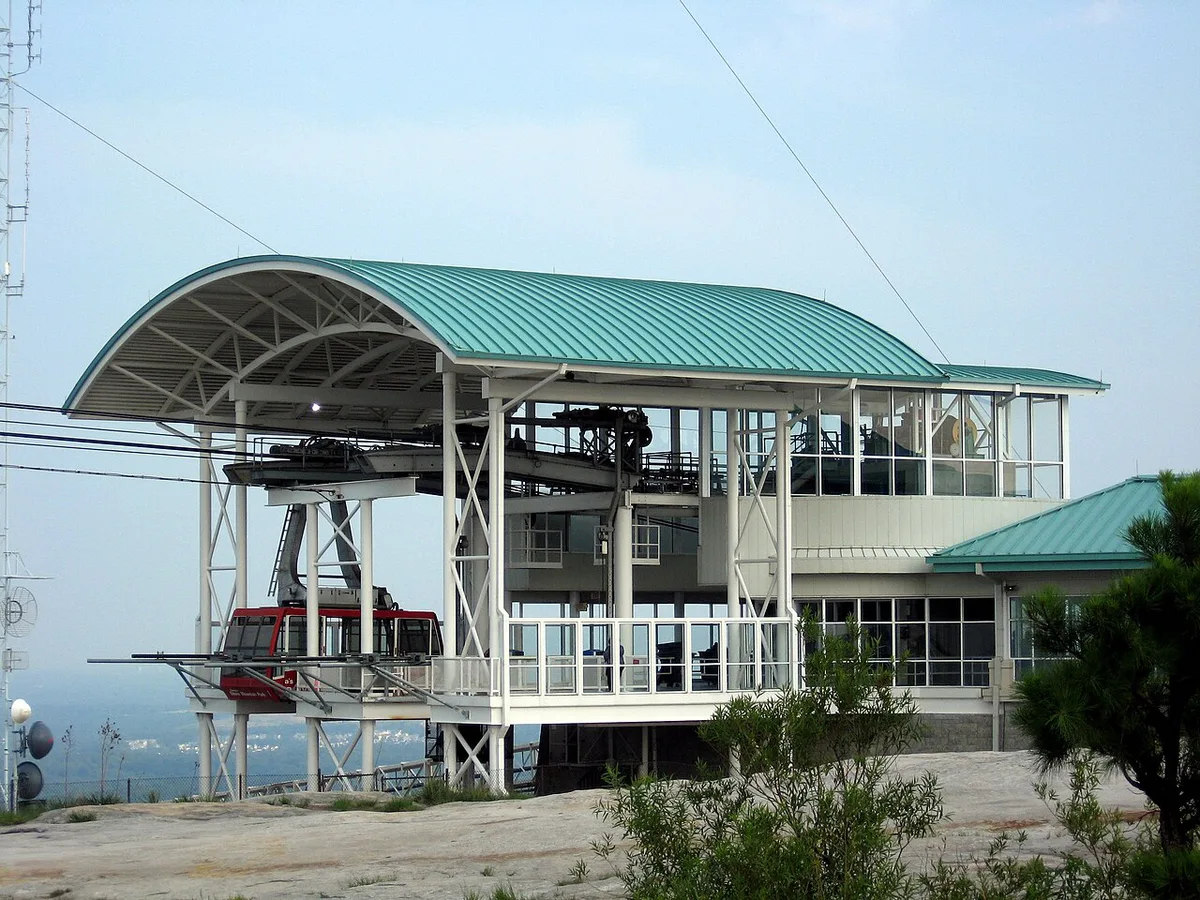 Granite dome of Stone Mountain with the Skyride cable car ascending — 1