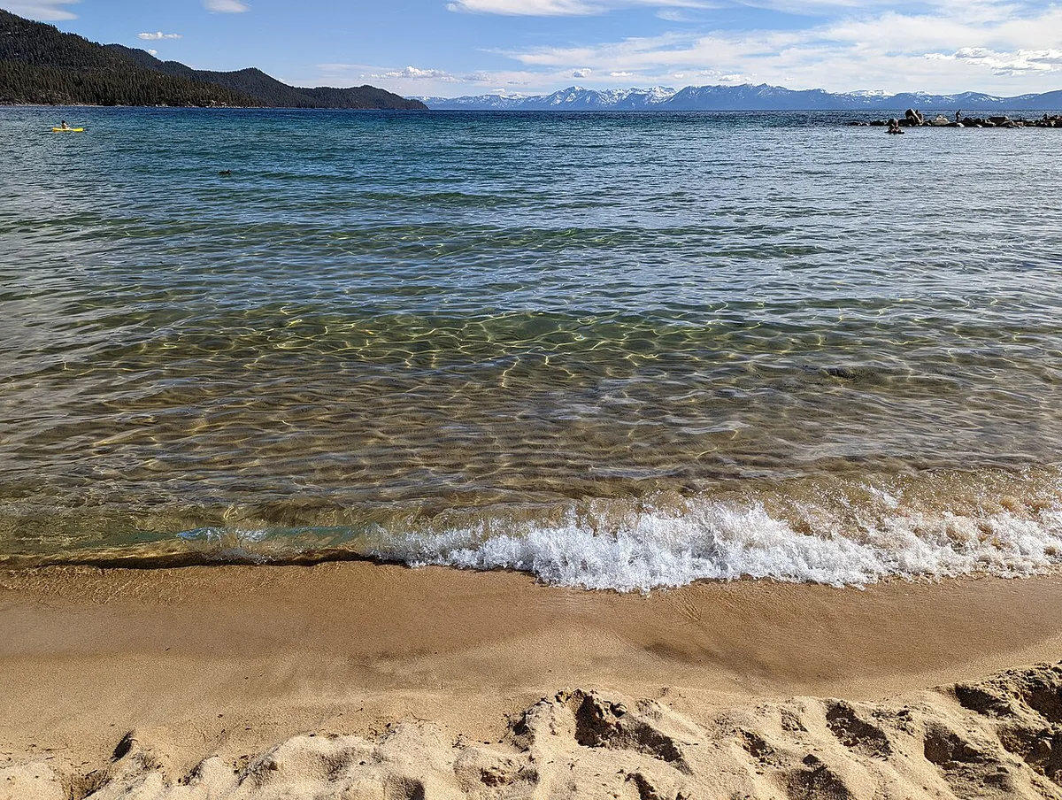 Families on the sandy cove between granite boulders at Sand Harbor, Lake Tahoe — 2