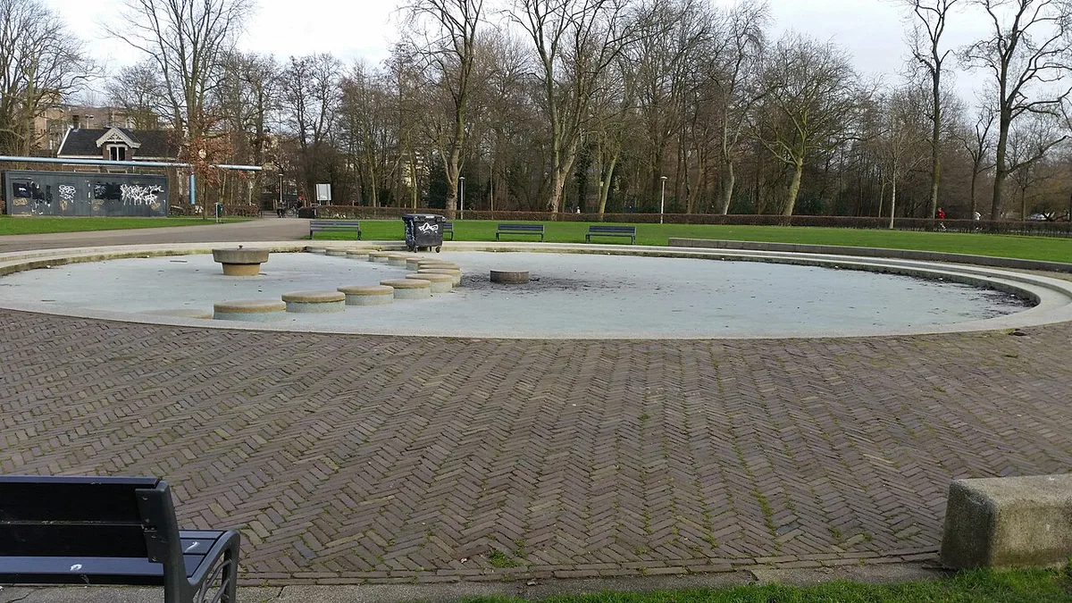 Families relaxing on the grass by a pond in Vondelpark Amsterdam — 2