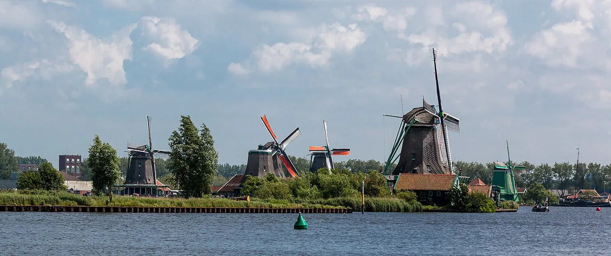 Historic windmills lining the Zaan river at Zaanse Schans — 1
